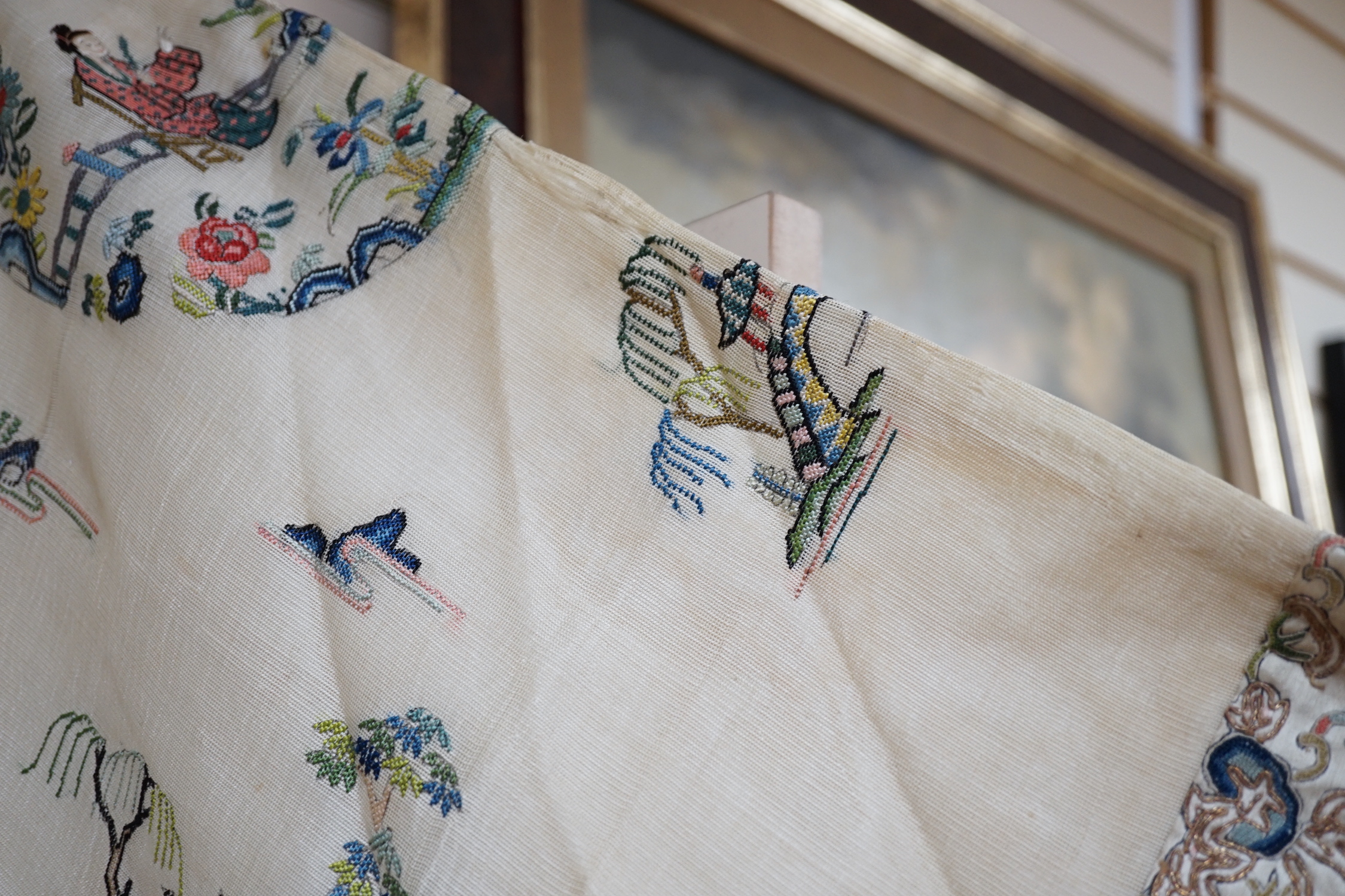 A late 19th/early 20th century Chinese gauze summer robe embroidered with flowers, figures and pagodas, 85cm high